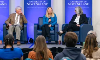 Three panelists discuss climate education onstage