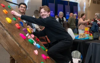 Students demonstrate their custom-made adaptive climbing wall