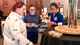 UNE students serve themselves at a luncheon in Innovation Hall