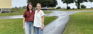 UNE student and mentor pose for outdoor photo