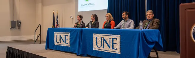 A group of interprofessional health care providers speaks to students as part of the conference