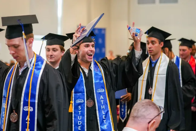 Students celebrate earning their diplomas at UNE's 2026 Commencement