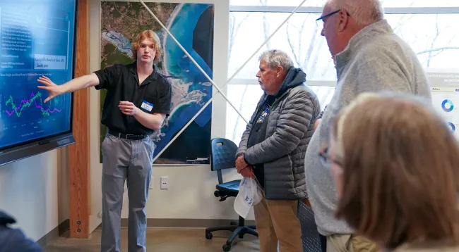 A UNE student delivers a presentation on weather data in UNE's Makerspace