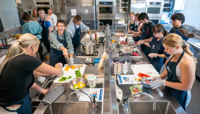Students cook together in UNE's Teaching Kitchen