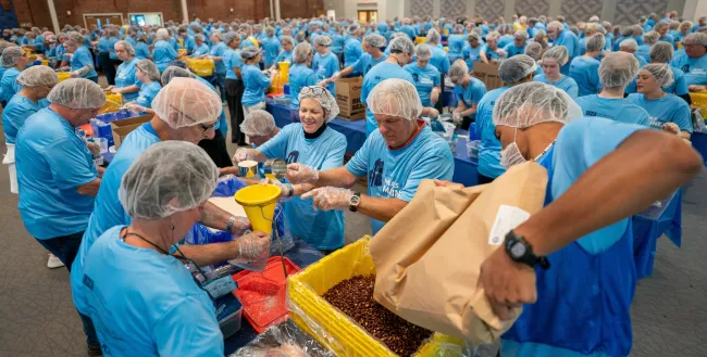 UNE community volunteers pack a record 200,000 meal kits to combat hunger across Maine