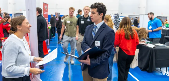A student meets with a job recruiter