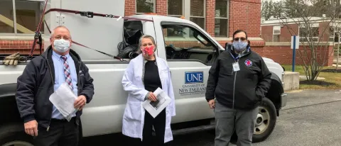 John Reid, left, facilities manager at the University of New England, stands with Karen Houseknecht, UNE’s associate provost for research, and Steven Boucouvalis, emergency operations coordinator with the Maine Center for Disease Control and Prevention. The ultra-cold freezer was delivered to a Maine CDC facility in a location that’s being kept secret for security reasons