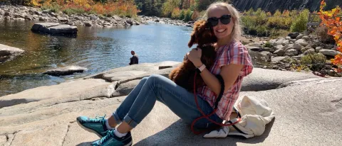 Outdoor photo of Julie Beauchesne holding a dog