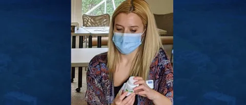 Student Alexa Michaud checks a patient's medication