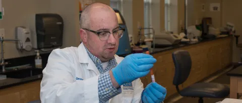 Researcher studies in laboratory