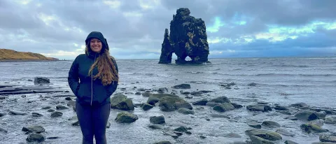 Ariana Telzerow stands in front of the water in Iceland