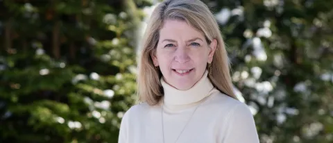 Beth Taylor-Nolan, new dean of UNE Online, poses for a portrait against the trees