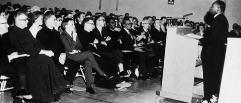Martin Luther King, Jr. speaking to a crowd at St. Francis College