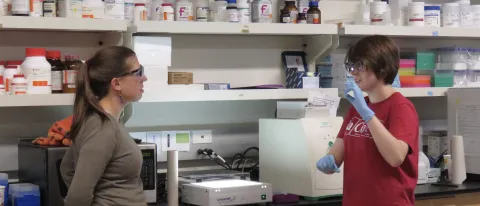 Eva Rose Balog works with student Laura Marvin in her lab on UNE’s Biddeford Campus in 2017.