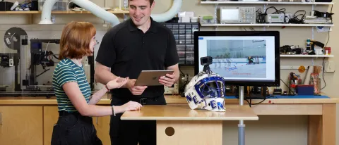 Students in makerspace with goal-training device