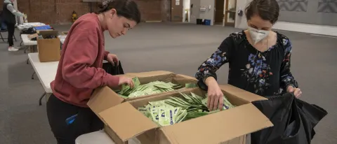 Two students add fentanyl test strips to harm reduction bags