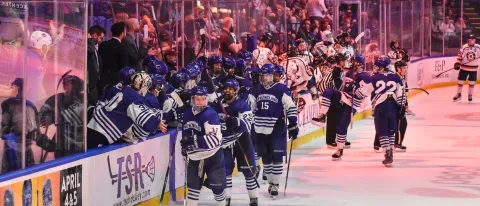 The team celebrates on the ice