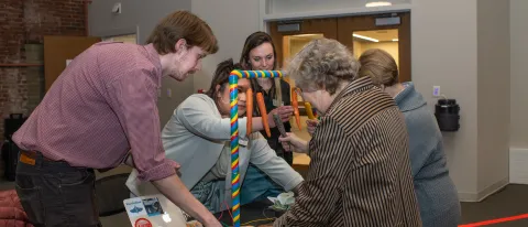 Expo attendees play with a sensory piano created by M.S.O.T. students