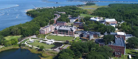 An aerial view of the Biddeford Campus near the river and ocean