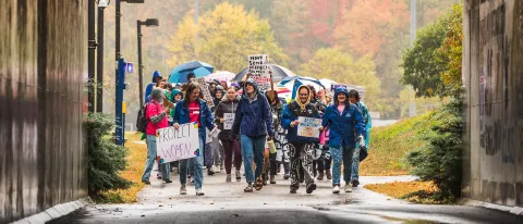 A group of students and faculty march through the UNE tunnel in support of women's reproductive rights