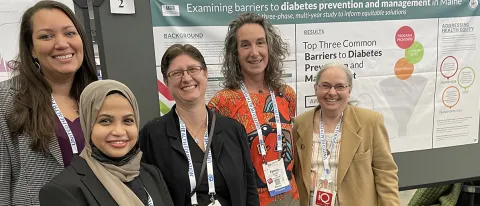 UNE researchers pose in front of a poster they presented at the American Public Health Association’s 150th Anniversary Annual Meeting 