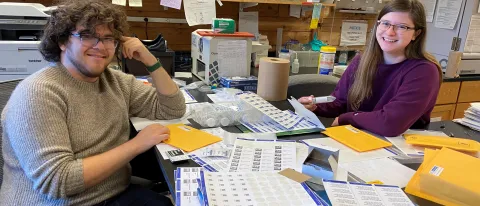 UNE student Brooke Parks sits with MDI Biological Laboratory independent study student, Adam Feher.