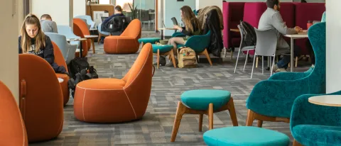 Several students studying in the Commons