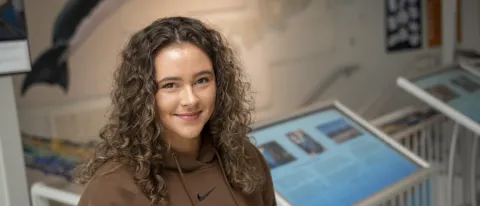 Portrait of Isabella Dube (Marine Affairs, ’24) in UNE's Marine Science Center