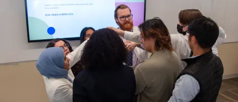 Osteopathic medical students try to unwind a "human knot" as part of a communication exercise