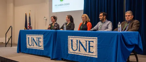 A group of interprofessional health care providers speaks to students as part of the conference