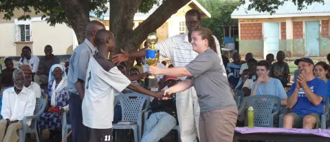UNE students and Kenyan school children participating in NYADEC’s Football for the Environment program.