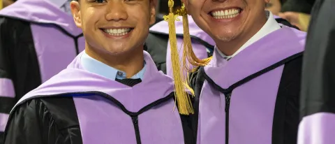 UNE graduates smile for the camera at Commencement