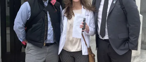 Three representatives from UNE pose outside the Maine State House. They are Ed Cervone, Bethany Miles, and Austin Vaughan..