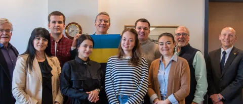 Members of a Ukrainian delegation pose with UNE President James Herbert and Associate Provost Mike Sheldon