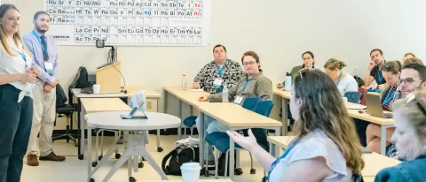Conference attendees gather for a session in a UNE classroom