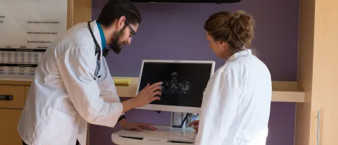 two UNE medical students look at screen