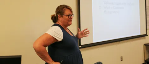 teacher standing in front of screen teaching
