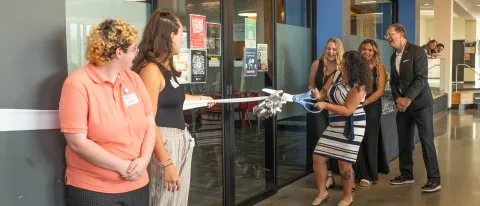 Andrea cuts the grand opening ribbon. 