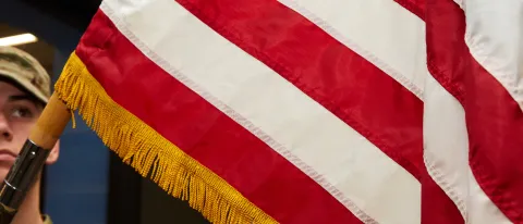 An Army ROTC member holds an American flag