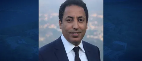 Headshot of Younes Abouyoub against a blue backdrop