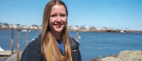 Portrait of a woman smiling in front of the ocean