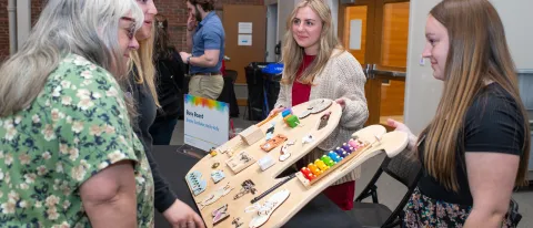 People observe a sensory board 