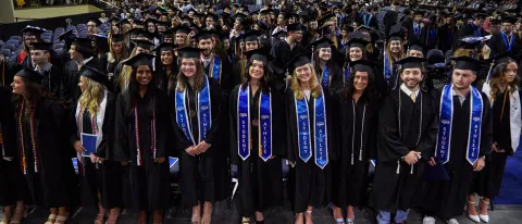 UNE graduates pose at the Cross Insurance Arena in Portland