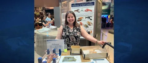 A UNE researcher poses for a photo with her research materials at the Smithsonian natural history museum