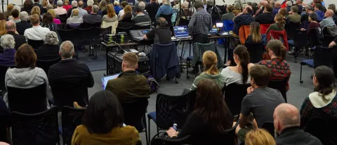 A large crowd gathers to watch a panel of speakers discuss the election in the Harold Alfond Forum room 283
