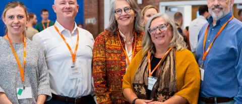 A group of UNE researchers and administrators pose for a photo