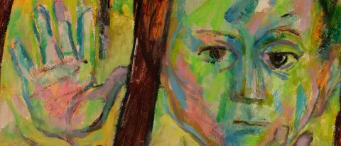 A child is painted in various shades of green