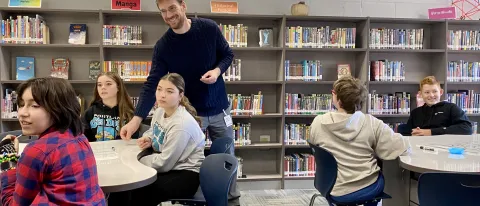 A UNE professor interacts with middle schoolers from Saco at Maine Bioscience Day