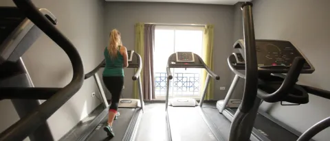 A woman runs on a treadmill