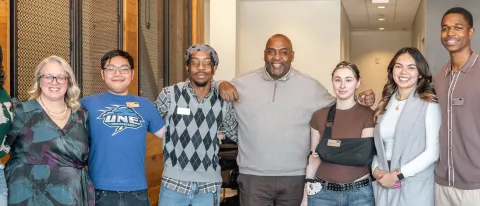 Students and staff pose with alumni speaker Mark Montgomery